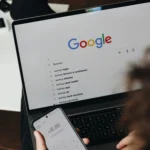 A guy using google search engine on laptop