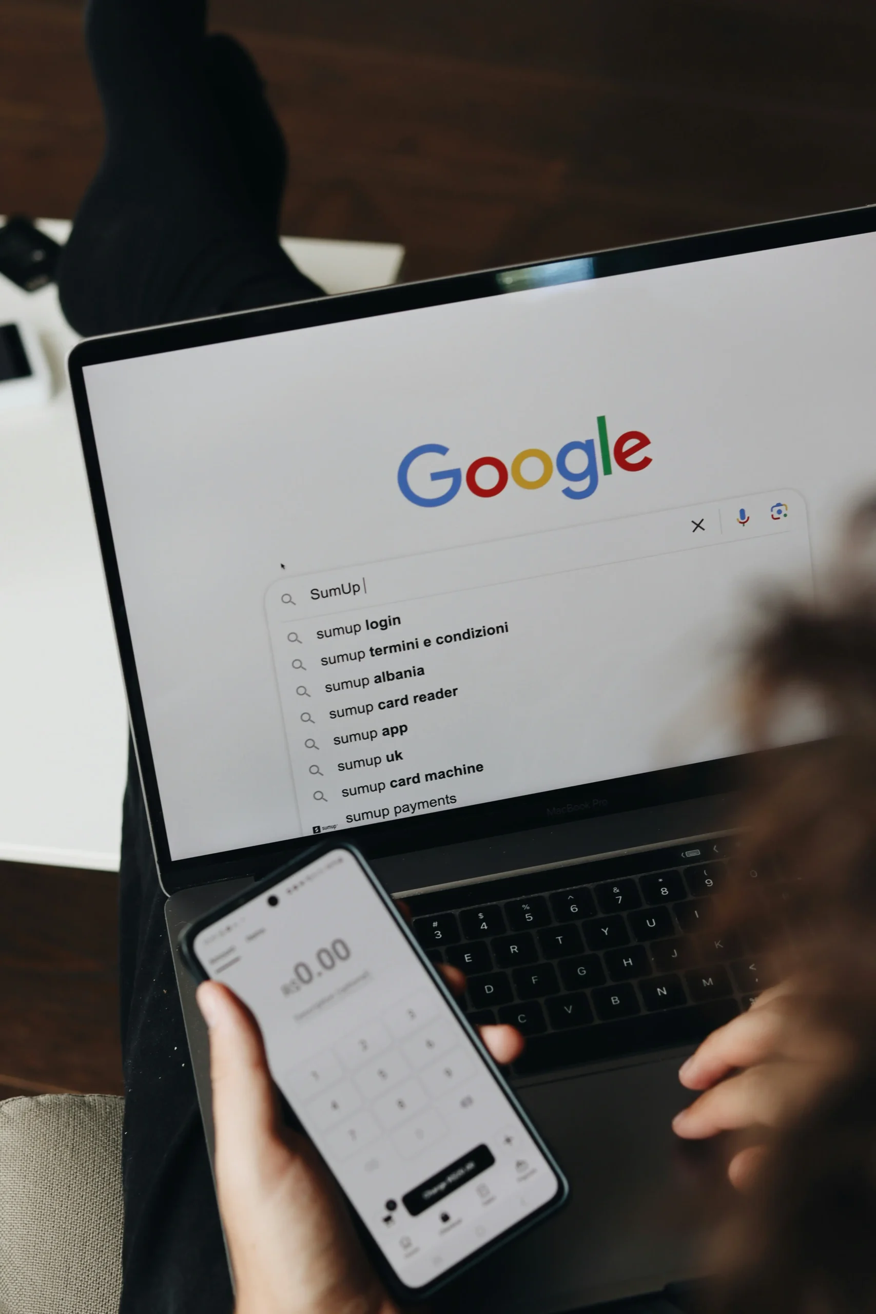 A guy using google search engine on laptop